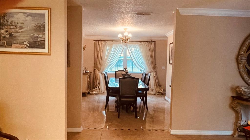 6850 Spring Rain Drive Orlando, FL 32819 - Photo 9 of 35 a view of a dining room with furniture and a window