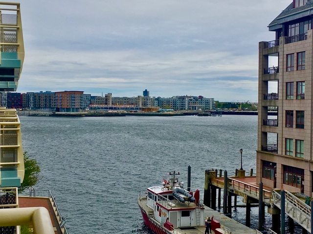 a view of roof deck with outdoor seating and city view
