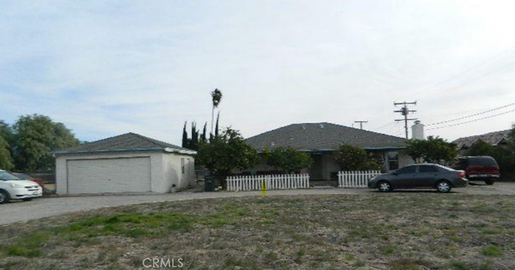 505 North Maple Avenue Rialto, CA 92376 - Photo 1 of 1 a front view of a house with a garden and parking space