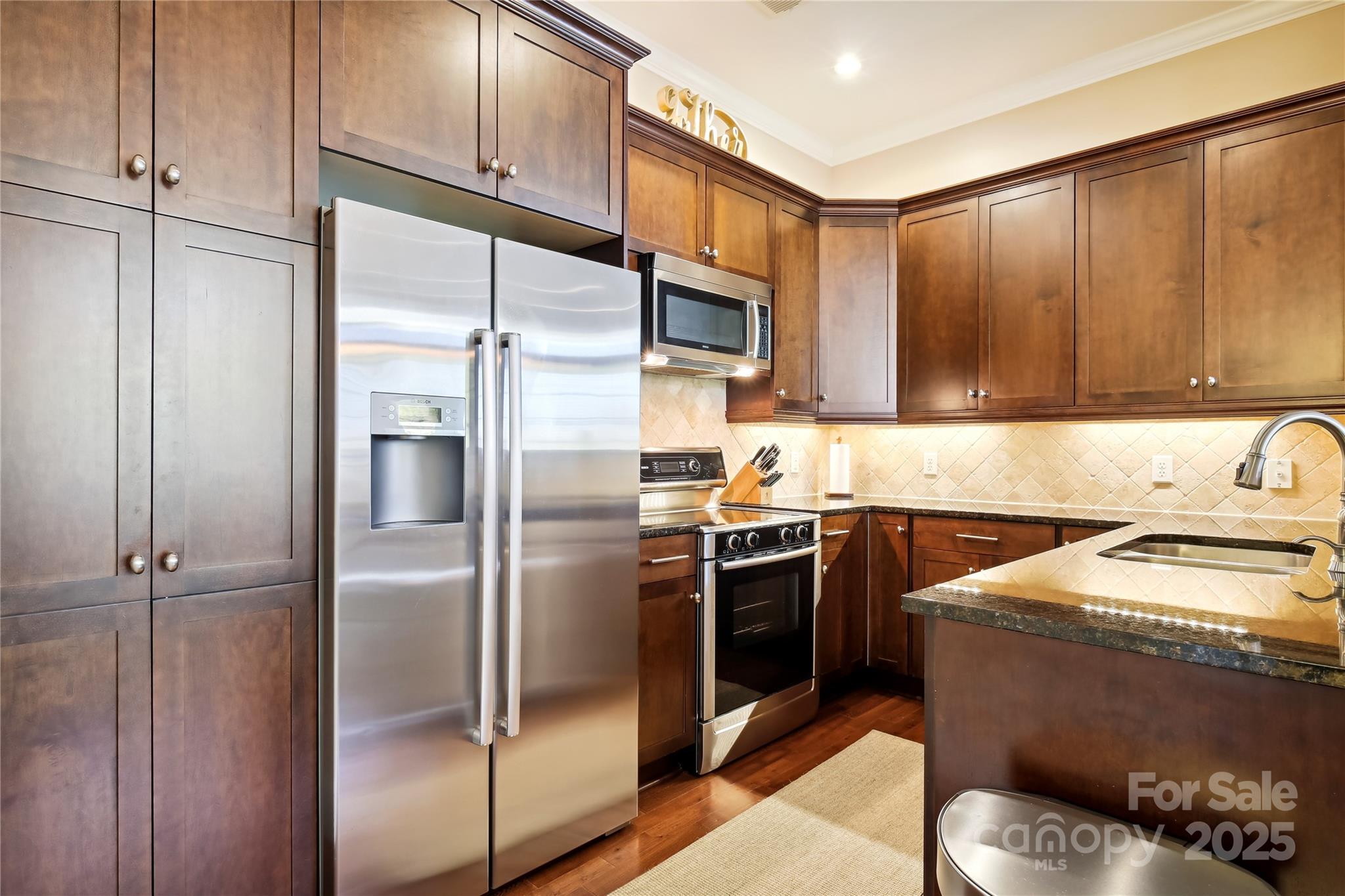 5425 Closeburn Road, Unit 309 Charlotte, NC 28210 - Photo 4 of 14 a kitchen with granite countertop stainless steel appliances and a refrigerator