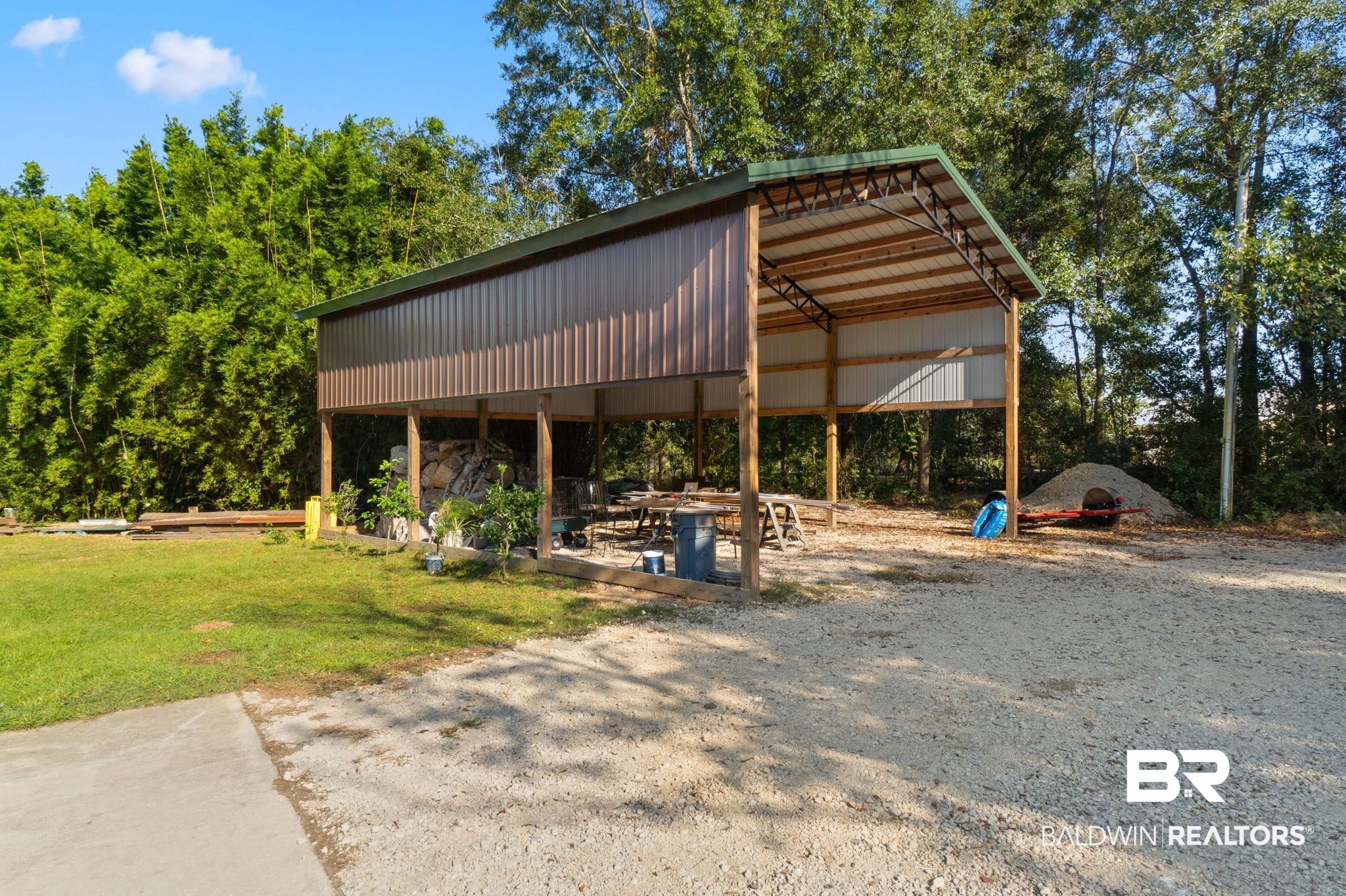 27300 C R Watson Road Robertsdale, AL 36567 - Photo 30 of 35 View of vehicle parking with a carport and a lawn