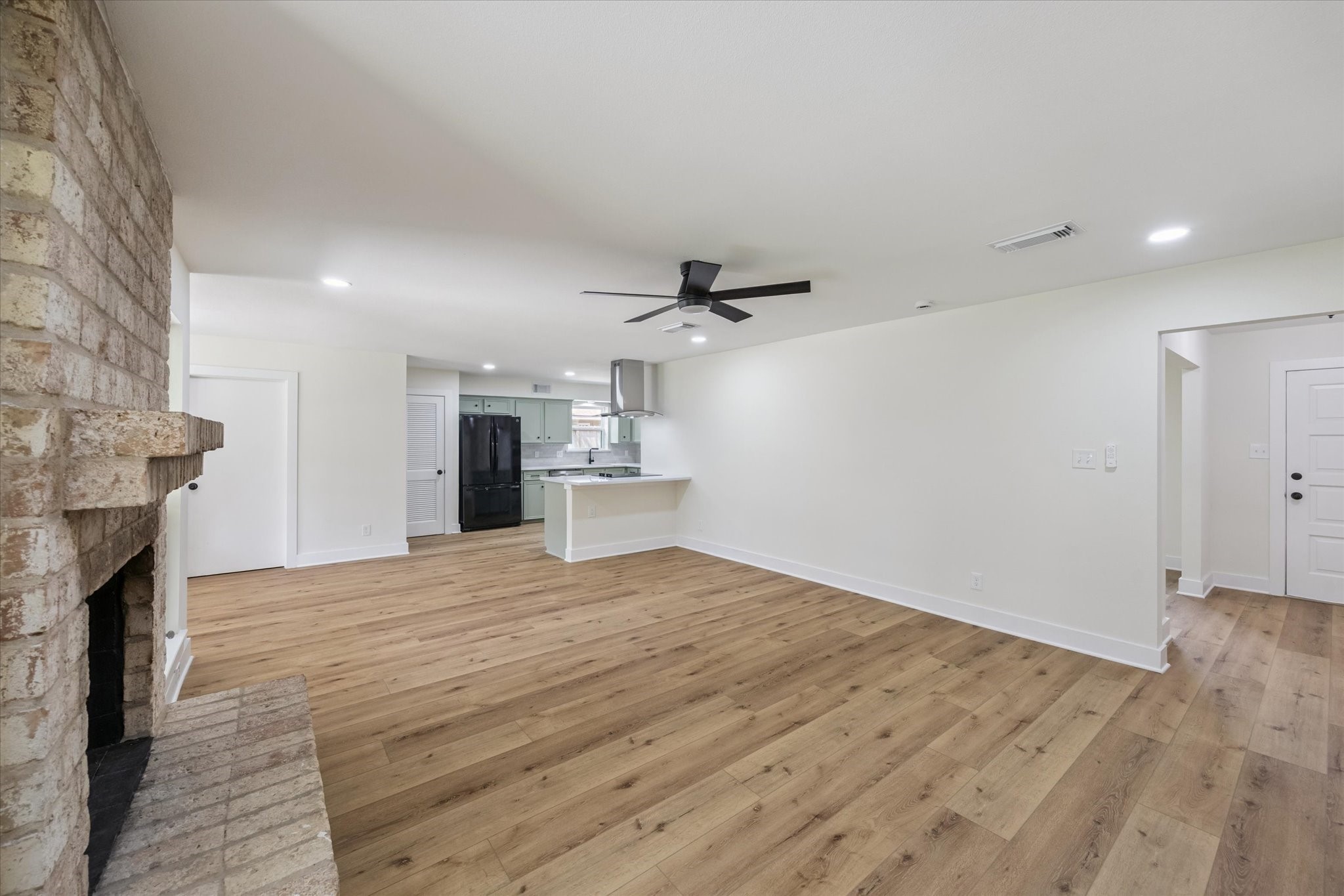 2723 Bernadette Lane Houston, TX 77043 - Photo 11 of 32 a view of empty room with wooden floor and fireplace