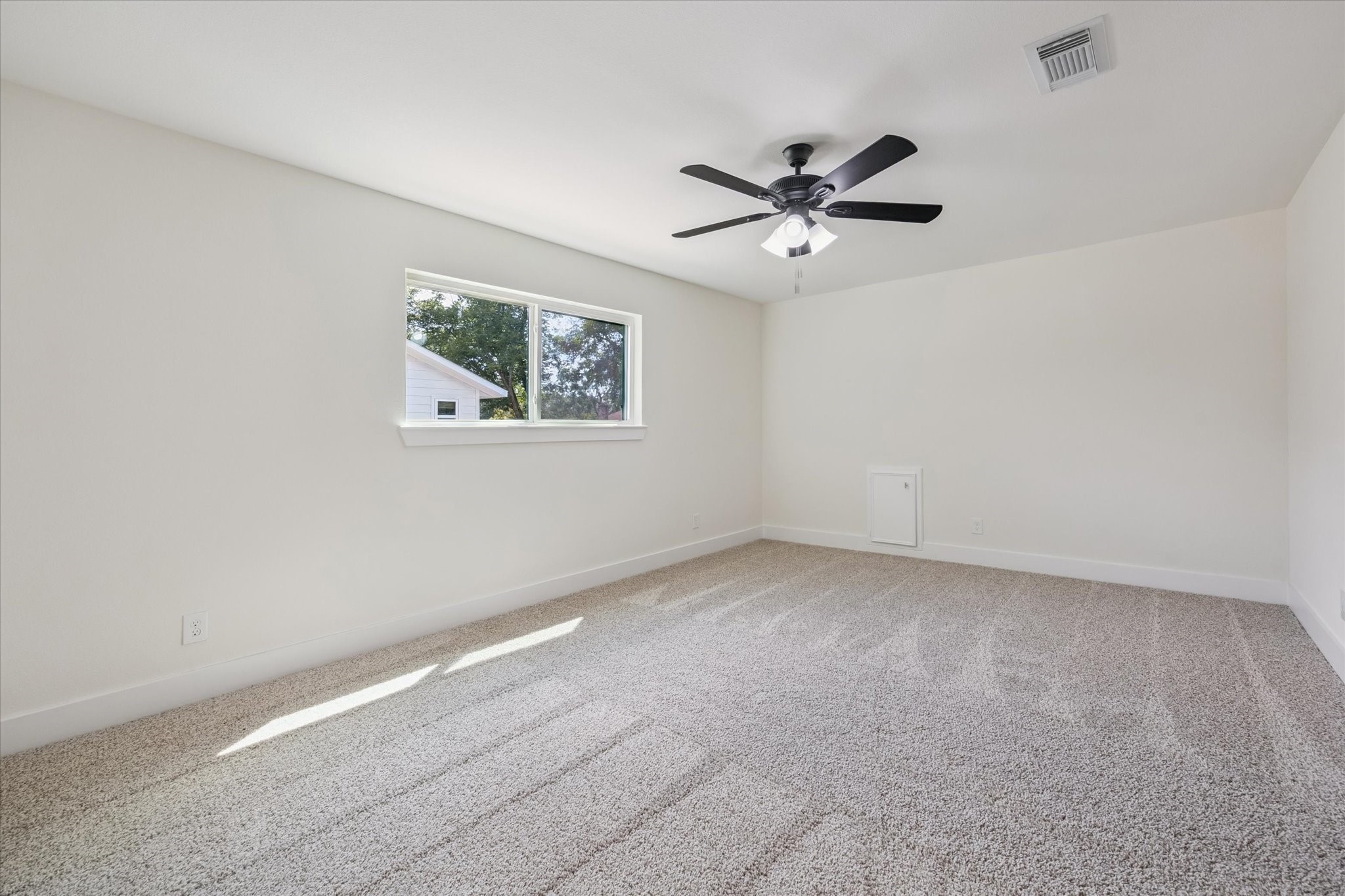 2723 Bernadette Lane Houston, TX 77043 - Photo 19 of 32 an empty room with a window and a fan