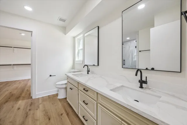 a bathroom with a double vanity sink and mirror