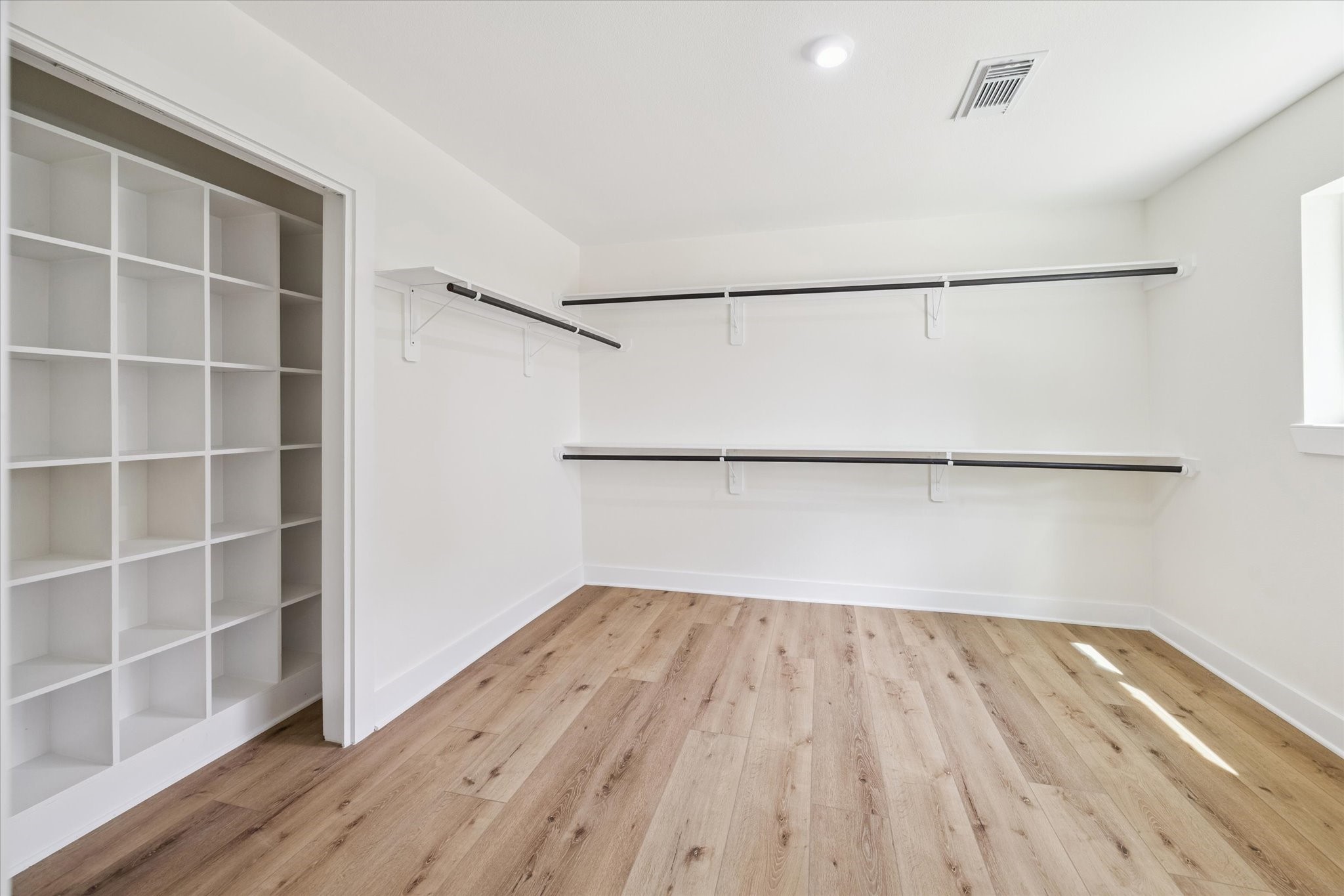 2723 Bernadette Lane Houston, TX 77043 - Photo 28 of 32 a view of an empty room with wooden floor and a window