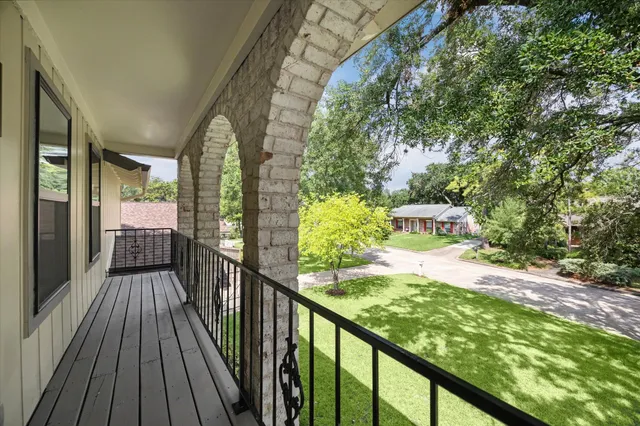 a view of a balcony with wooden floor