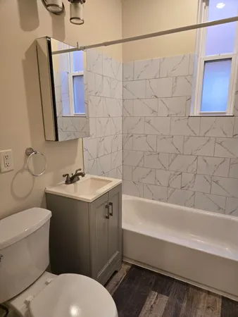 a bathroom with a sink toilet and shower