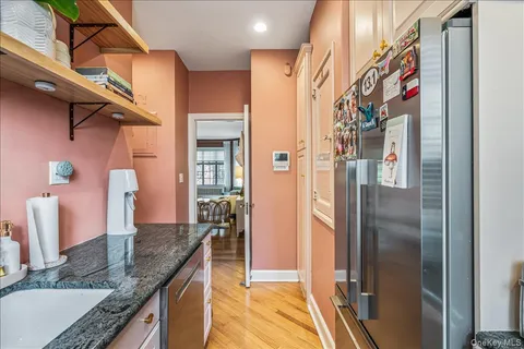 a kitchen with stainless steel appliances granite countertop a refrigerator and a sink
