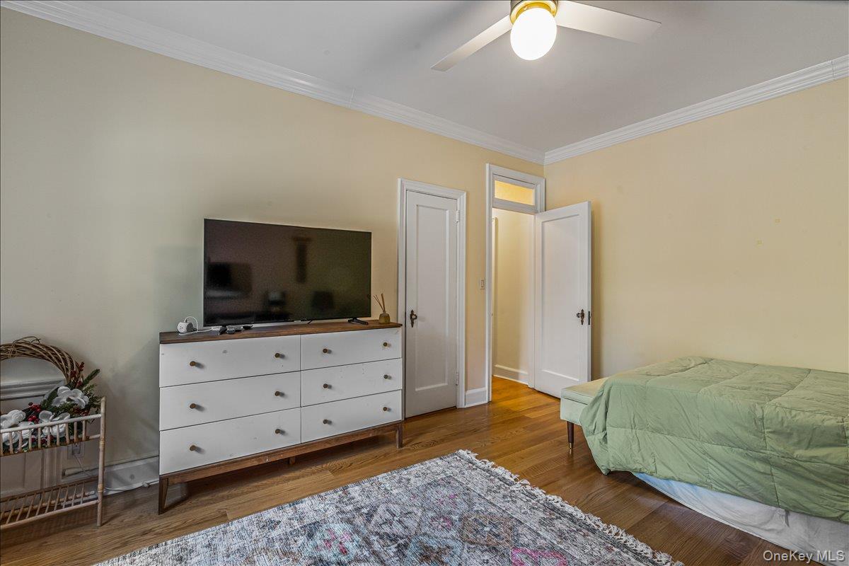 38-30 Douglaston Parkway, Unit G2 Queens, NY 11363 - Photo 17 of 19 a bedroom with a bed and flat screen tv