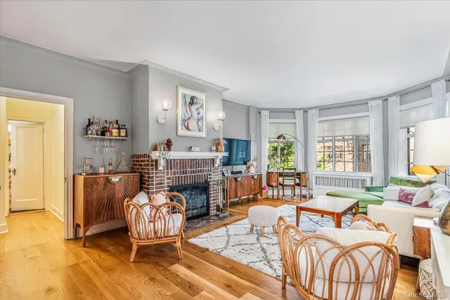 a living room with furniture a fireplace and a table