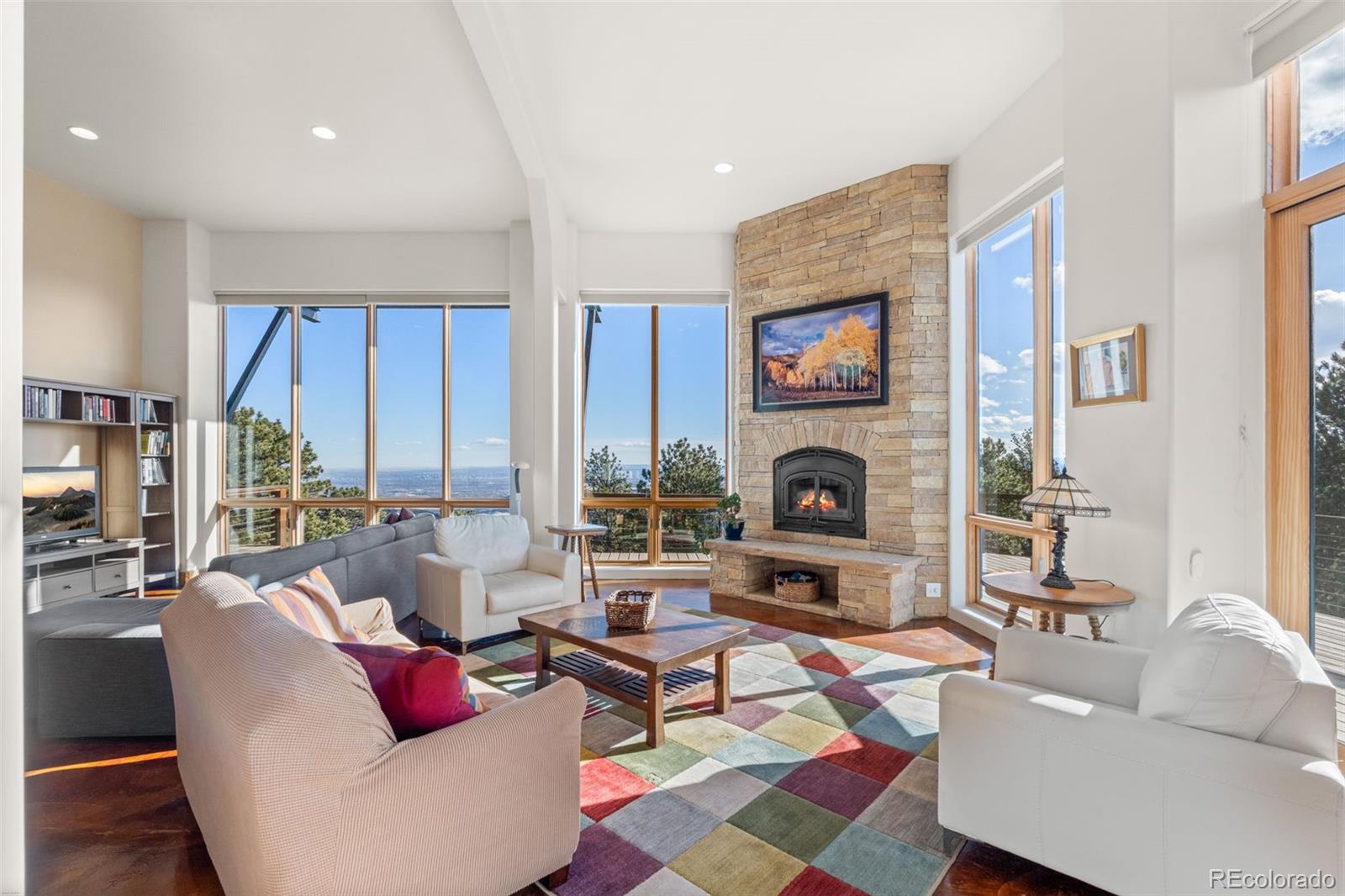 27659 Misty Road Golden, CO 80403 - Photo 13 of 50 a living room with furniture fireplace and a large window