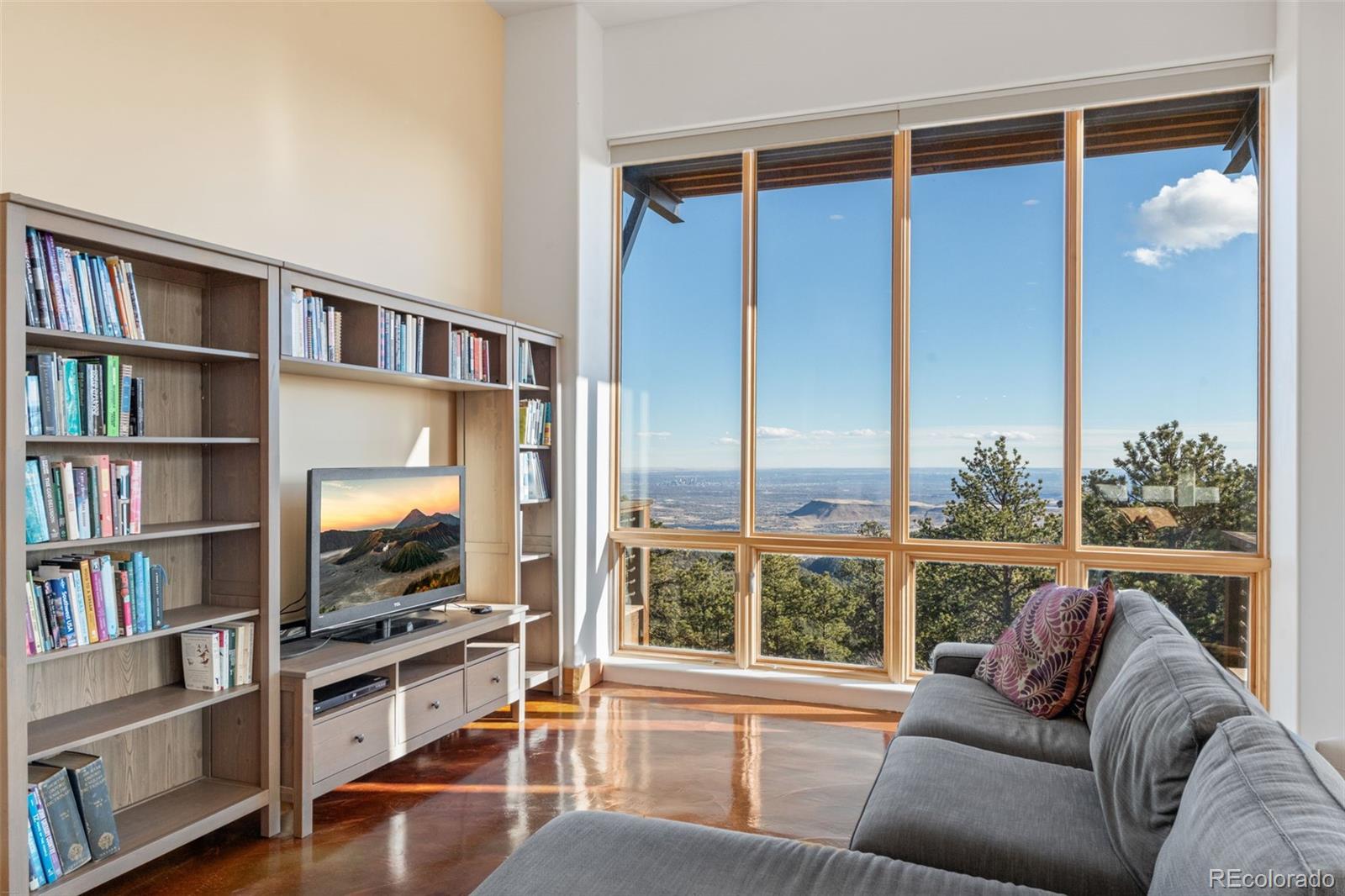 27659 Misty Road Golden, CO 80403 - Photo 14 of 50 a living room with furniture and a book shelf