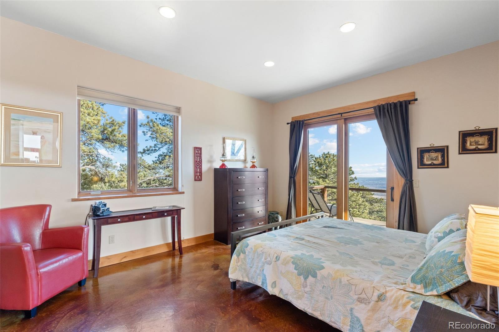 27659 Misty Road Golden, CO 80403 - Photo 25 of 50 a bedroom with a large bed and a large window