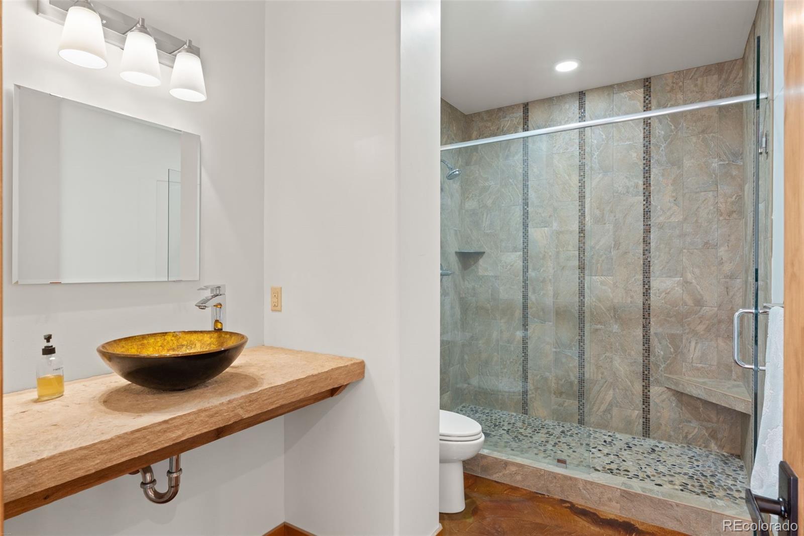 27659 Misty Road Golden, CO 80403 - Photo 30 of 50 a bathroom with a sink a toilet and shower