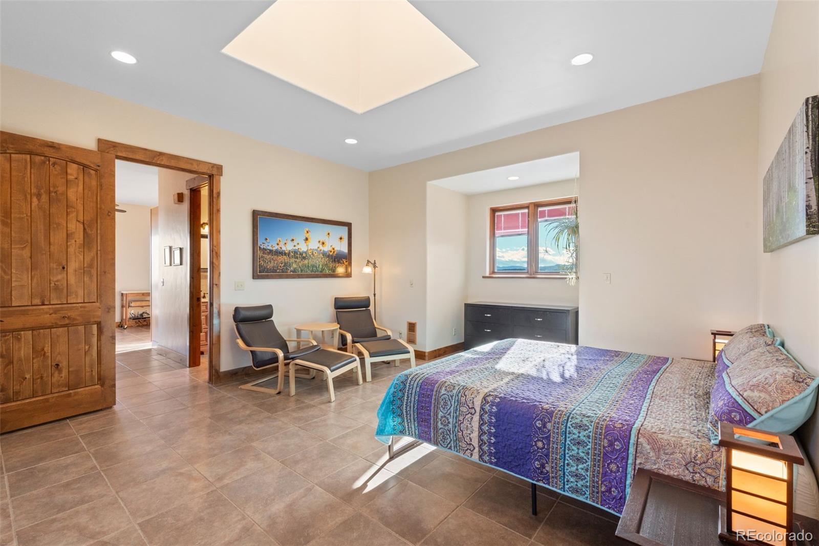27659 Misty Road Golden, CO 80403 - Photo 33 of 50 a bedroom with a bed and wooden floor