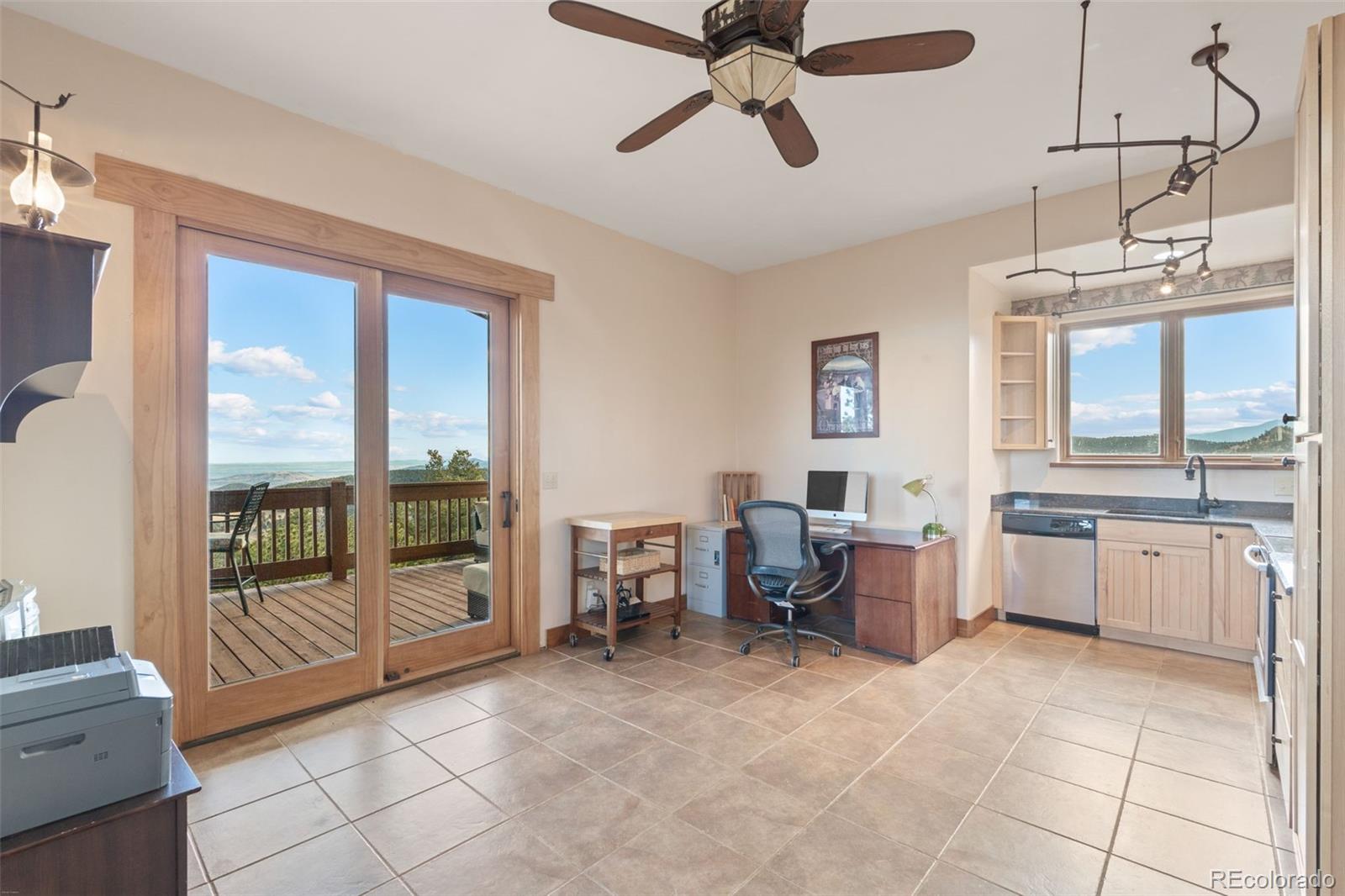 27659 Misty Road Golden, CO 80403 - Photo 35 of 50 a living room with furniture a flat screen tv and windows