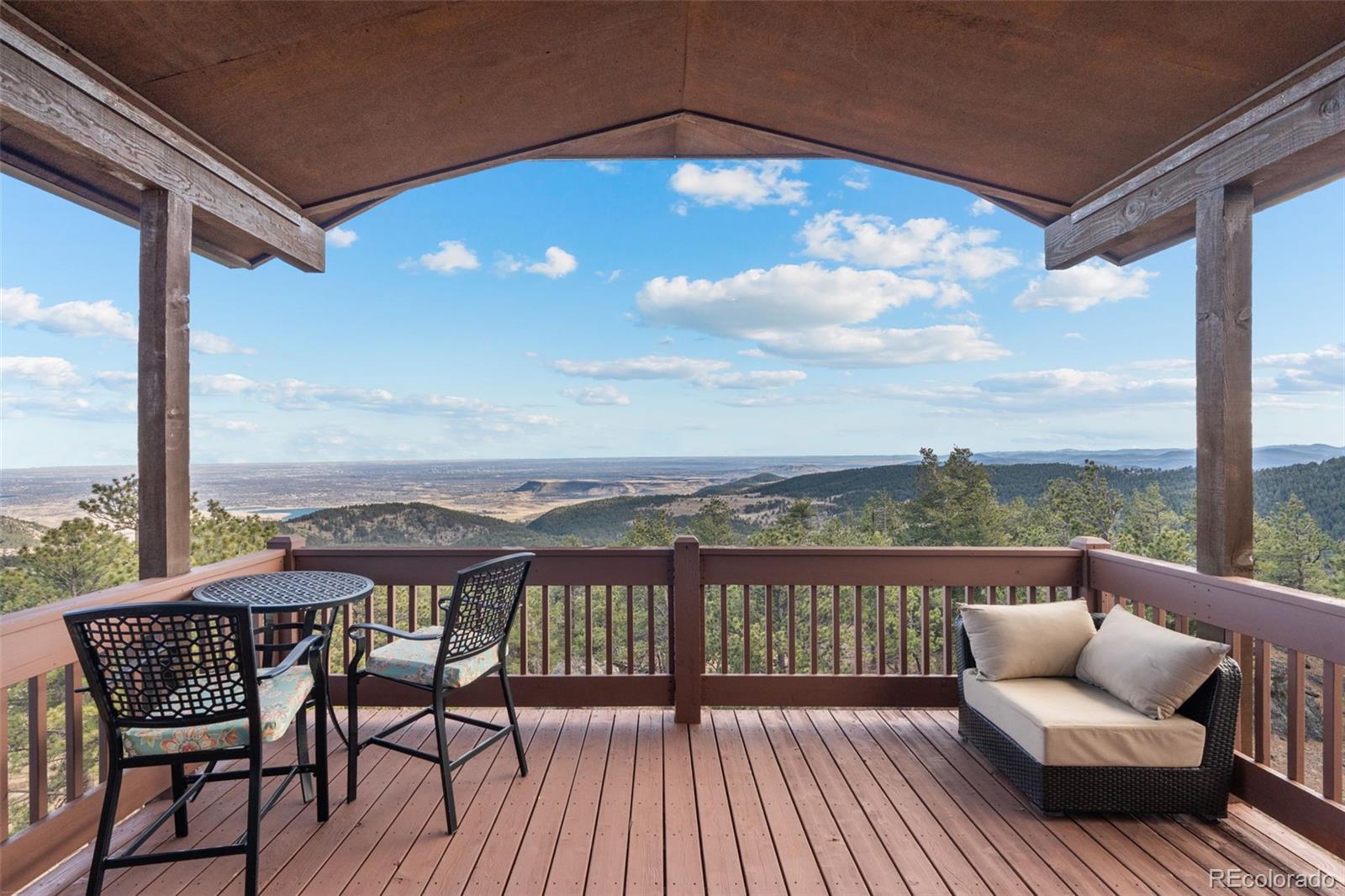 27659 Misty Road Golden, CO 80403 - Photo 36 of 50 a view of a chairs and table on the roof deck