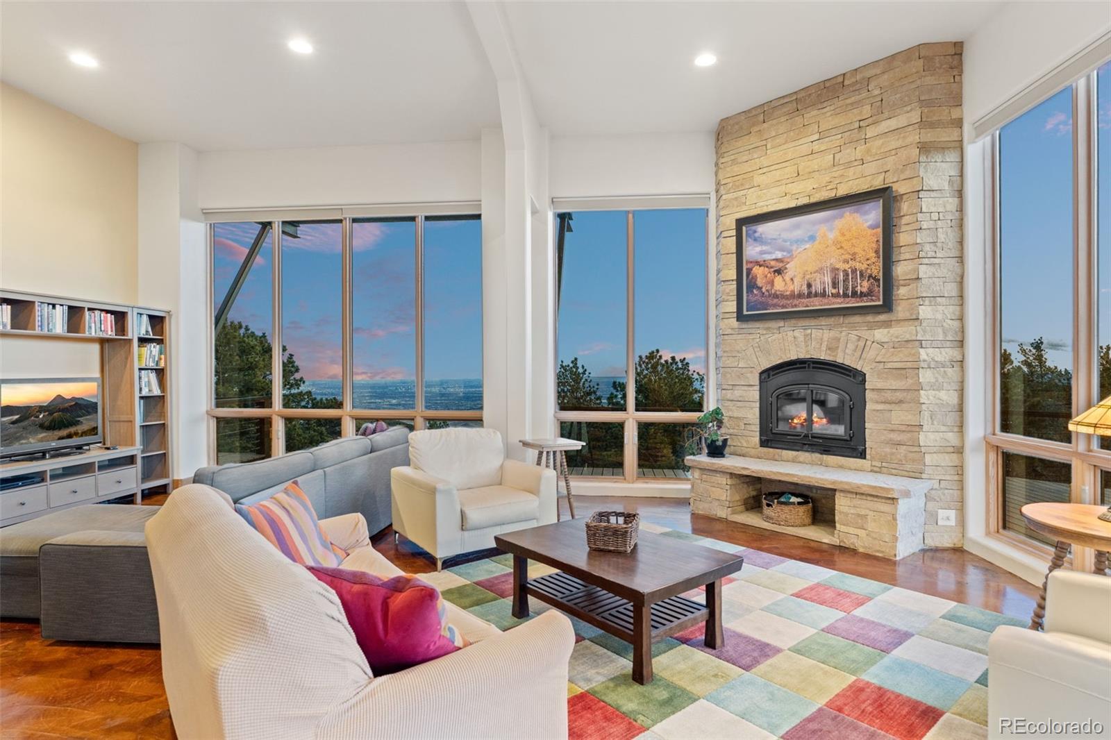27659 Misty Road Golden, CO 80403 - Photo 4 of 50 a living room with furniture a flat screen tv and a fireplace