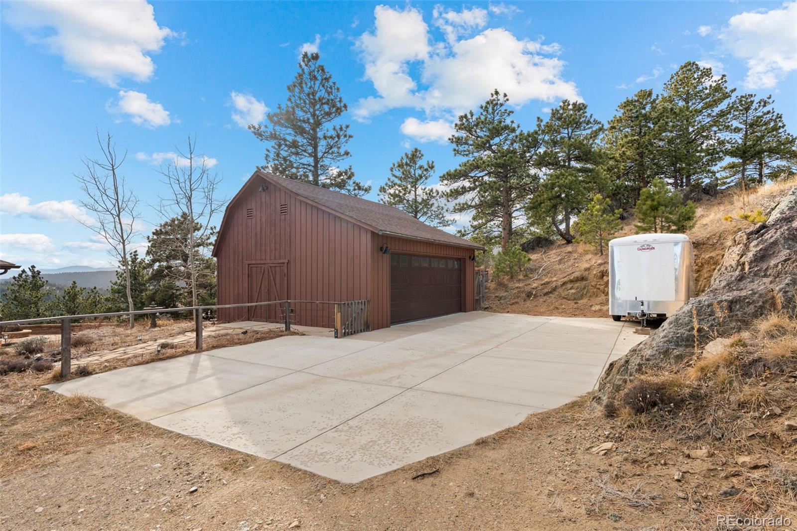 27659 Misty Road Golden, CO 80403 - Photo 44 of 50 a backyard of a house with table and chairs