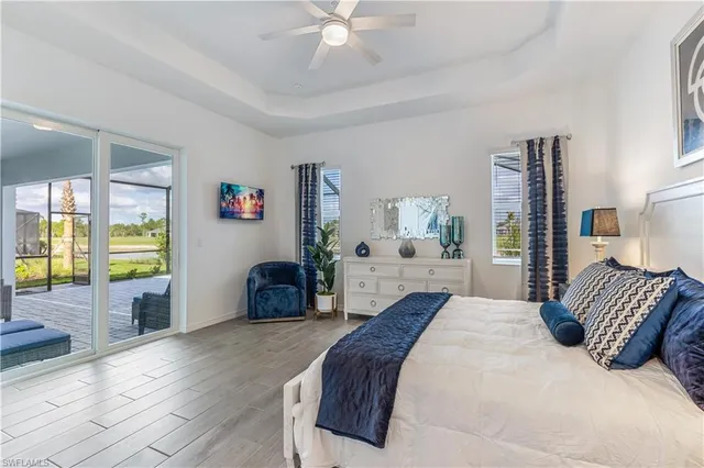 a bedroom with a large bed and a chandelier