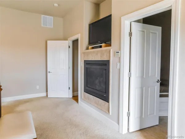 a view of a livingroom with an empty space and a kitchen