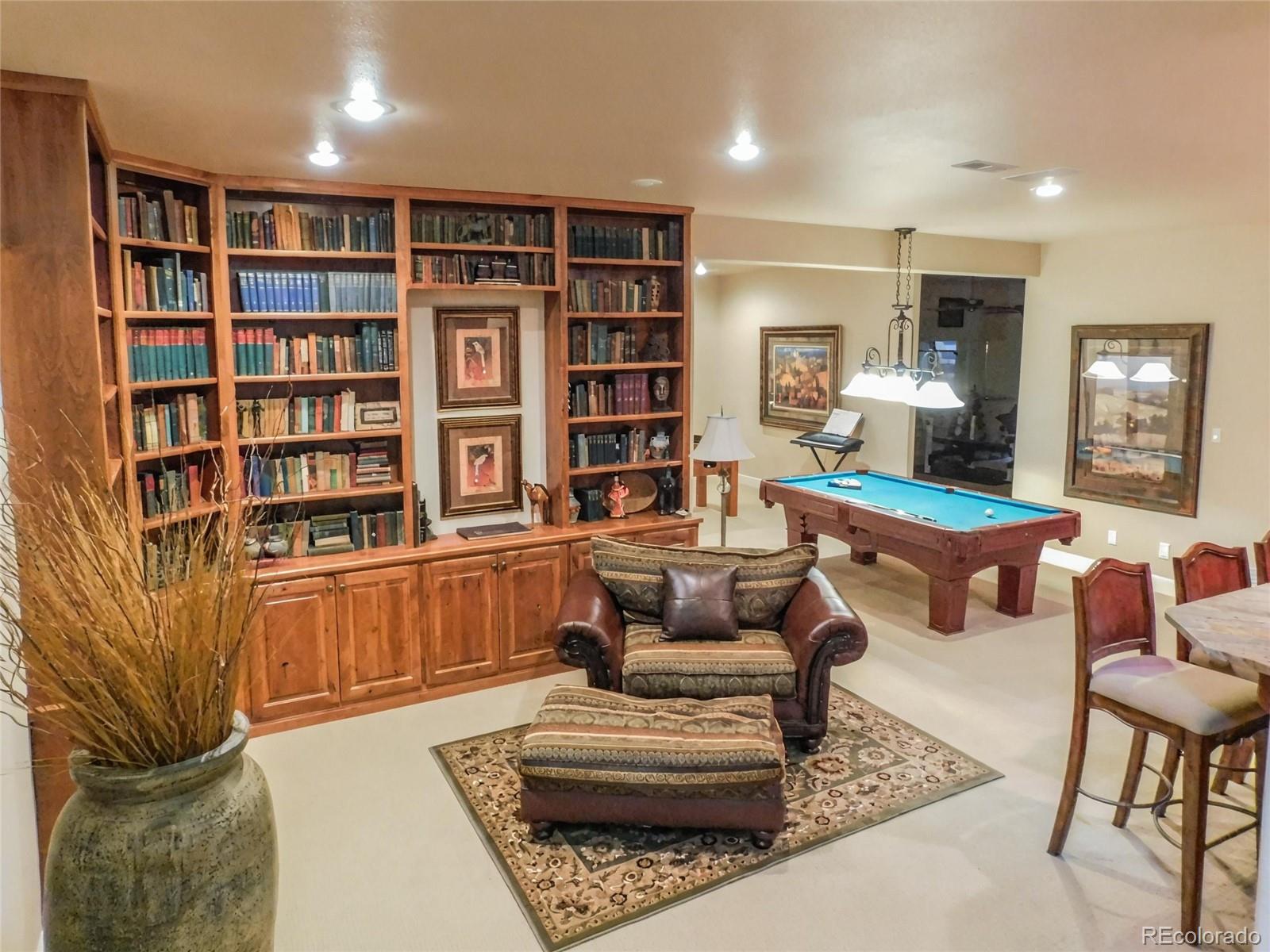 4351 Little Burnt Mill Road Pueblo, CO 81004 - Photo 17 of 45 a living room with furniture and a book shelf