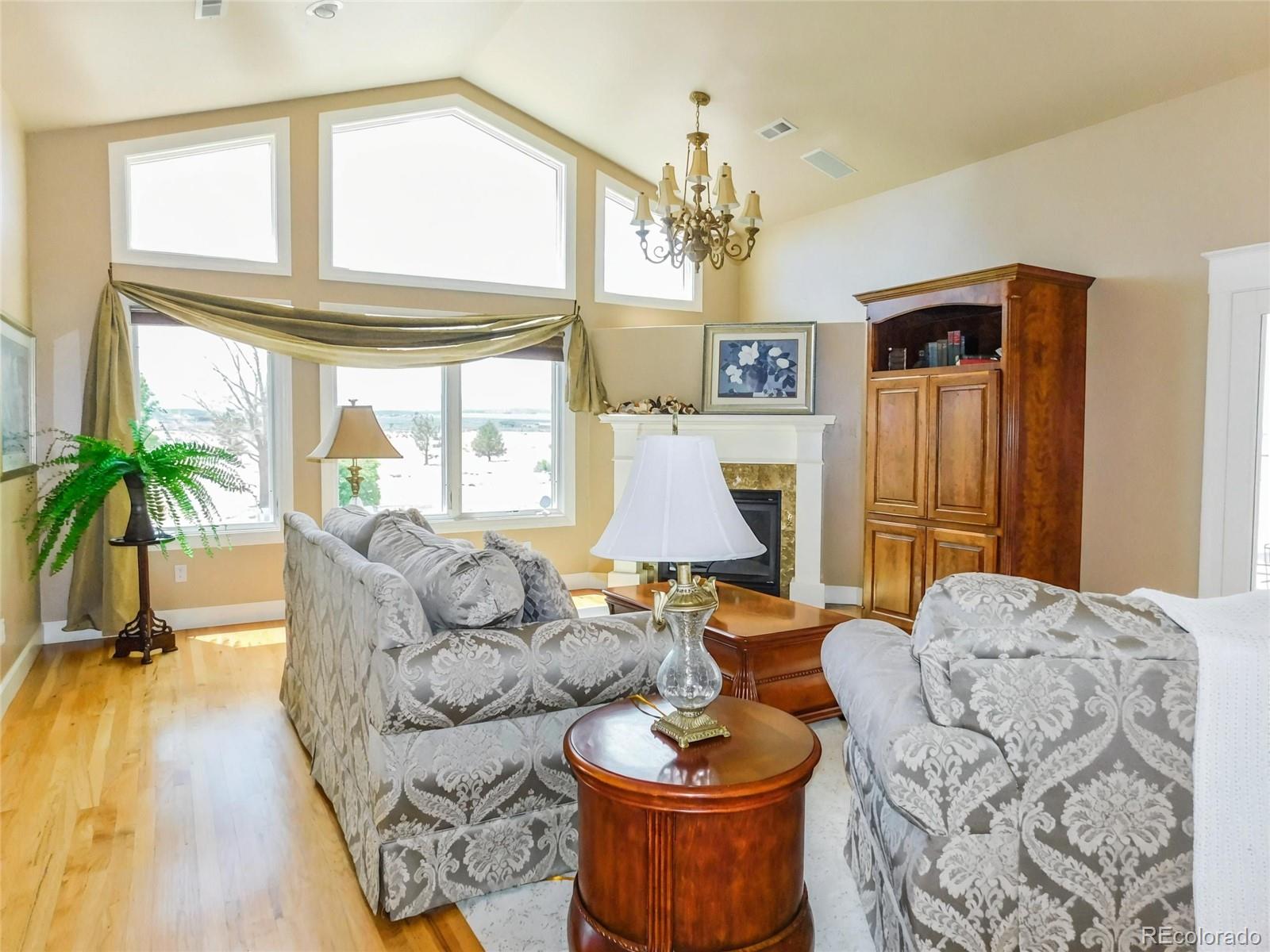 4351 Little Burnt Mill Road Pueblo, CO 81004 - Photo 6 of 45 a living room with furniture a chandelier and a large window