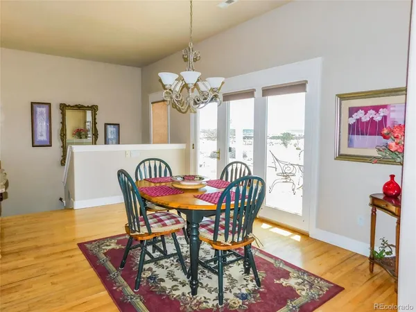 a view of a dining room with furniture wooden floor and a chandelier