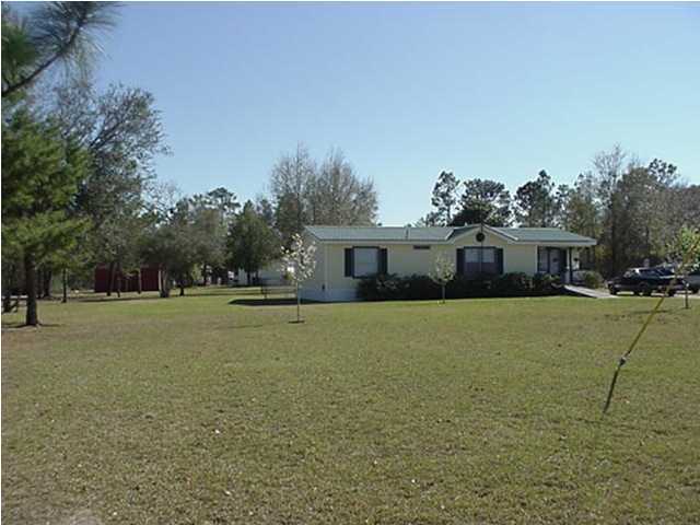 4397 Rebecca Road Crestview, FL 32539 - Photo 6 of 16 a front view of house with yard space and trees