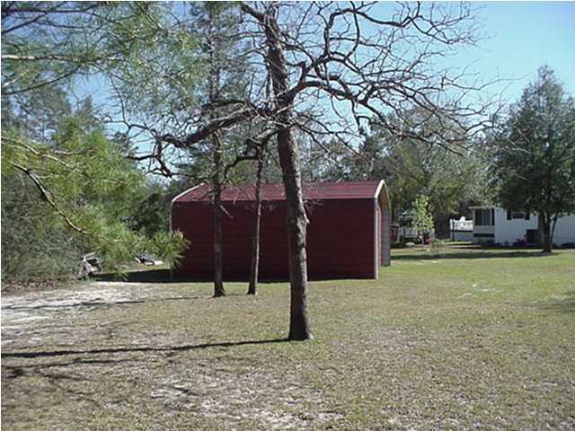 4397 Rebecca Road Crestview, FL 32539 - Photo 7 of 16 a backyard of a house with lots of green space