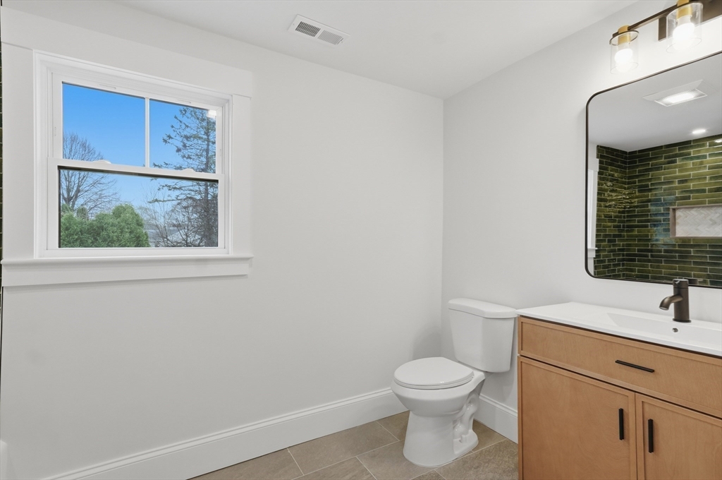 105 Stafford Road Lowell, MA 01852 - Photo 25 of 42 a bathroom with a toilet a sink and a mirror