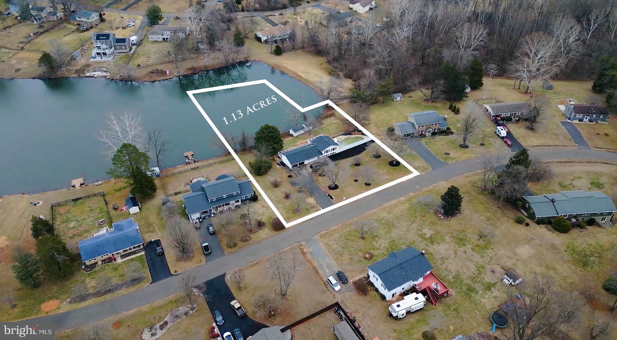 an aerial view of a house with a lake view