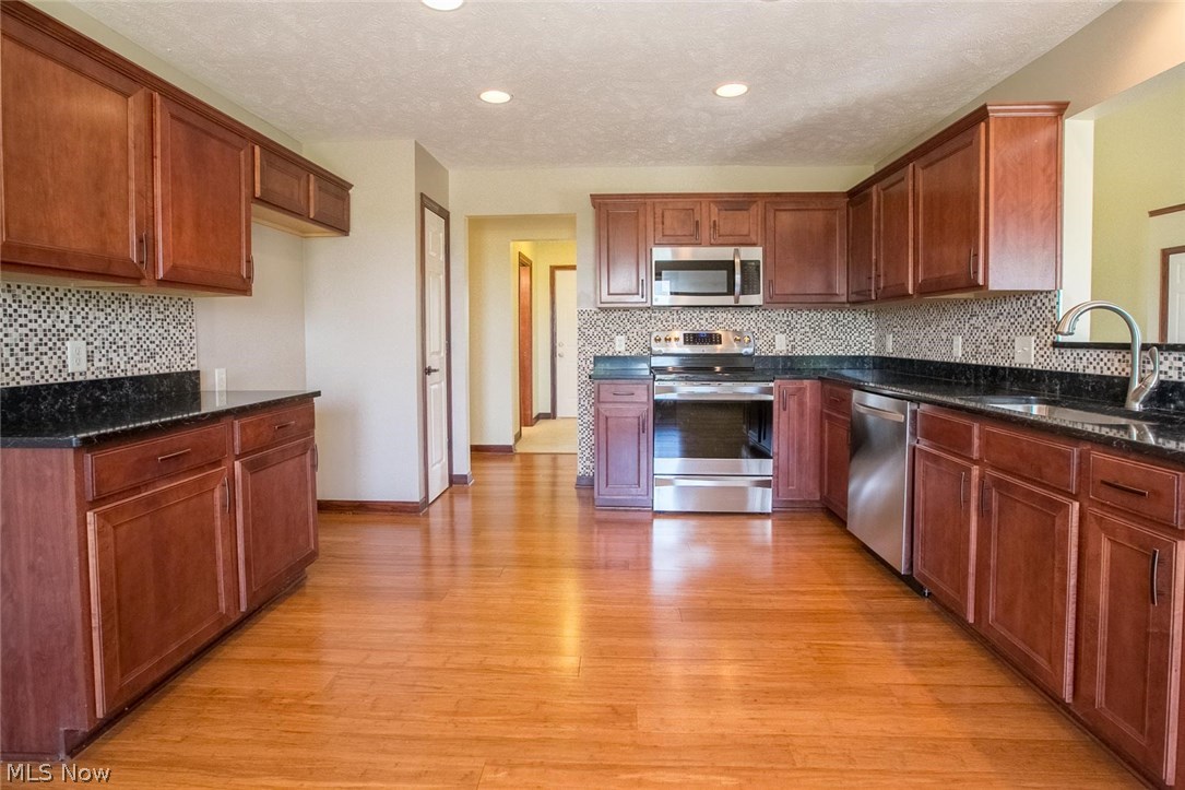 13719 Kelley Road Milan, OH 44846 - Photo 11 of 28 Kitchen with quartz counter tops and mosaic backsplash