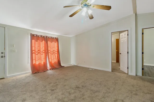 a kitchen with granite countertop a stove a sink and a refrigerator