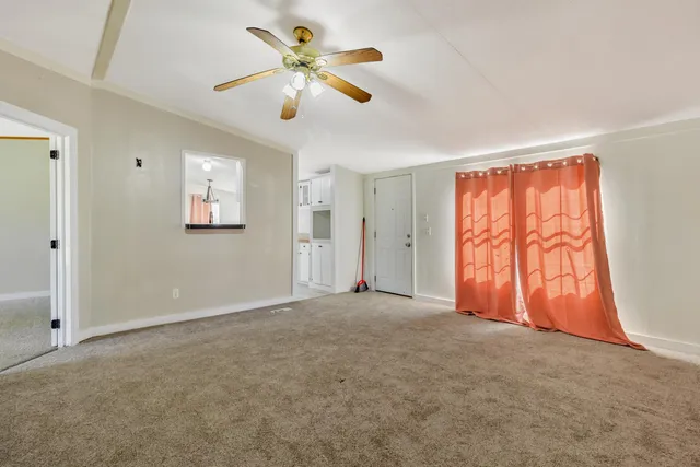 a kitchen with stainless steel appliances kitchen island a refrigerator sink and cabinets