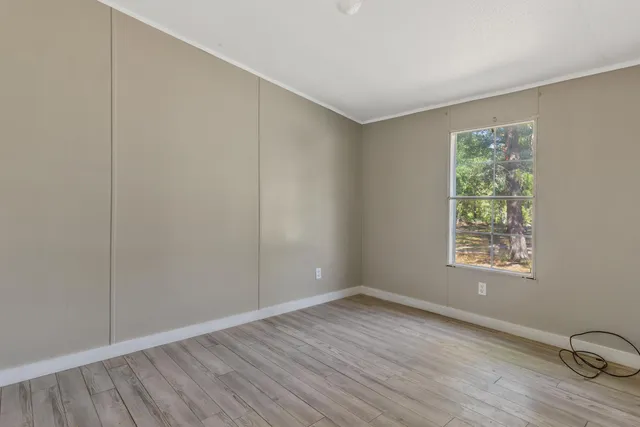 a aerial view of a house with a yard and lake view