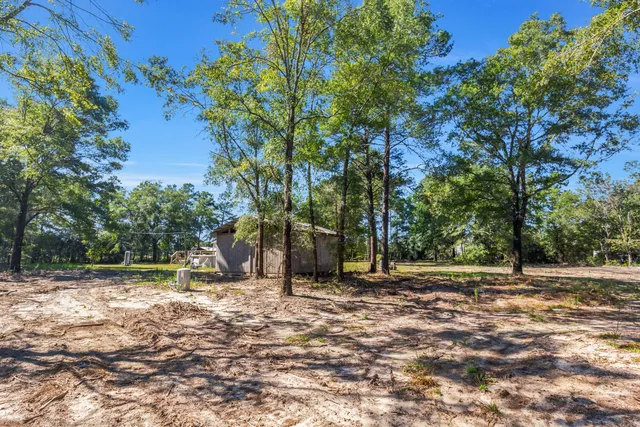 a front view of a house with a big yard