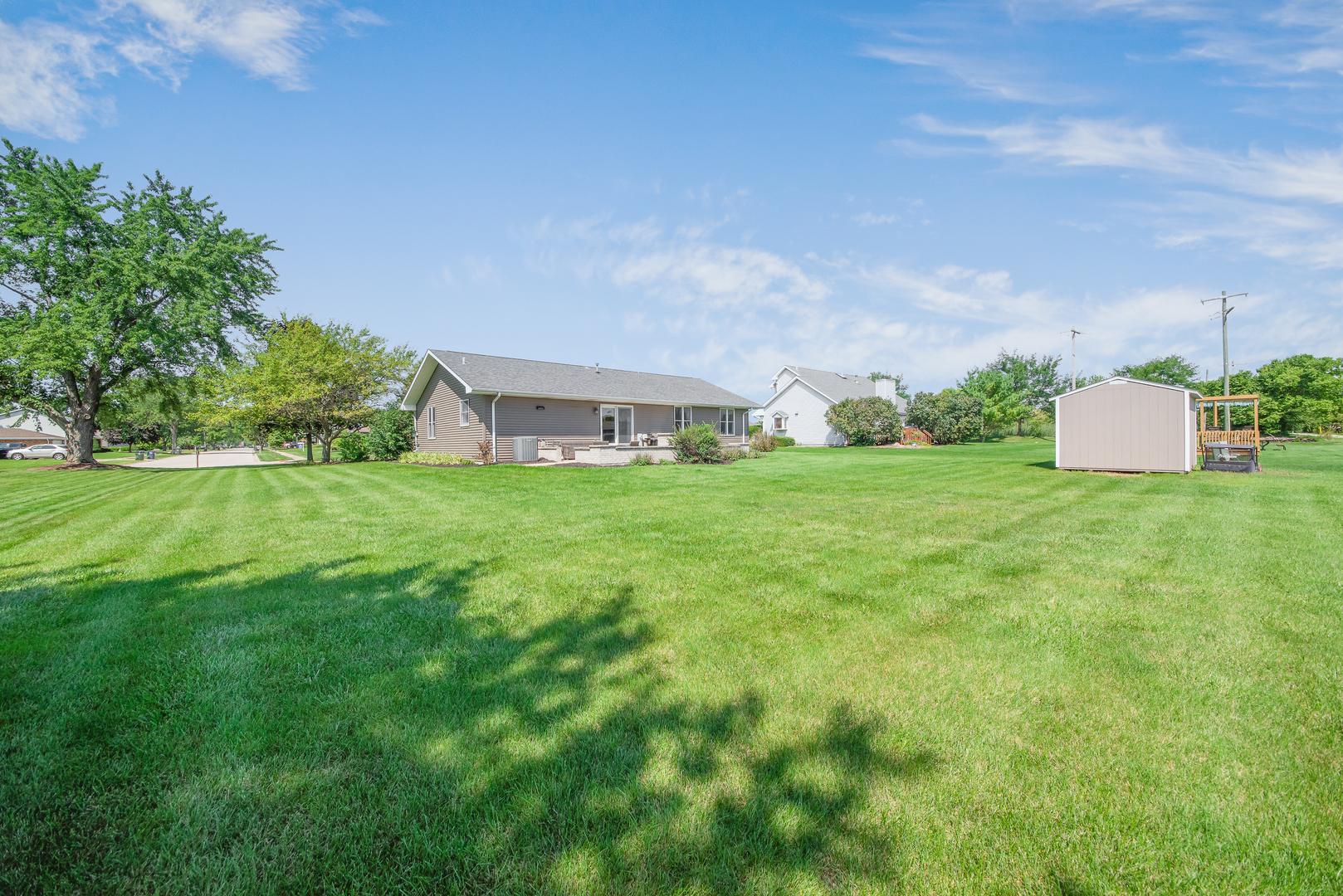200 Beechwood Drive Minooka, IL 60447 - Photo 18 of 26 a view of a house with a big yard and large trees
