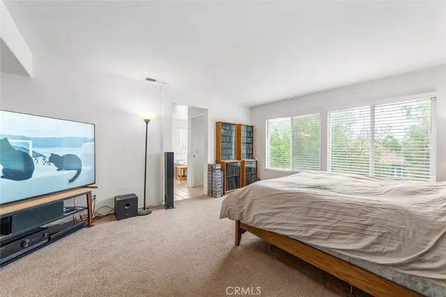 a spacious bathroom with a tub sink and mirror