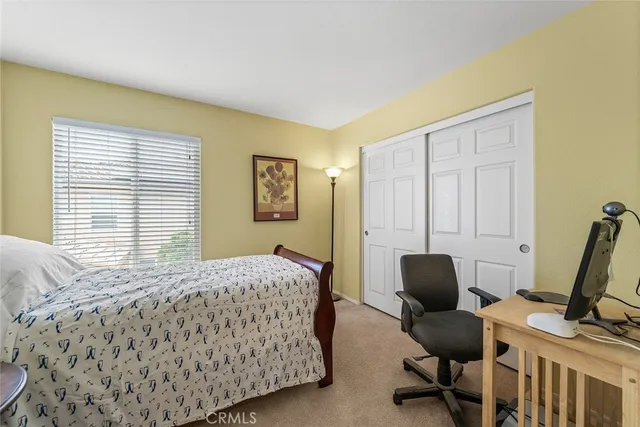 a living room with furniture a flat screen tv and a window