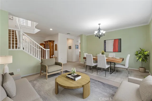 a living room with furniture a rug and a chandelier