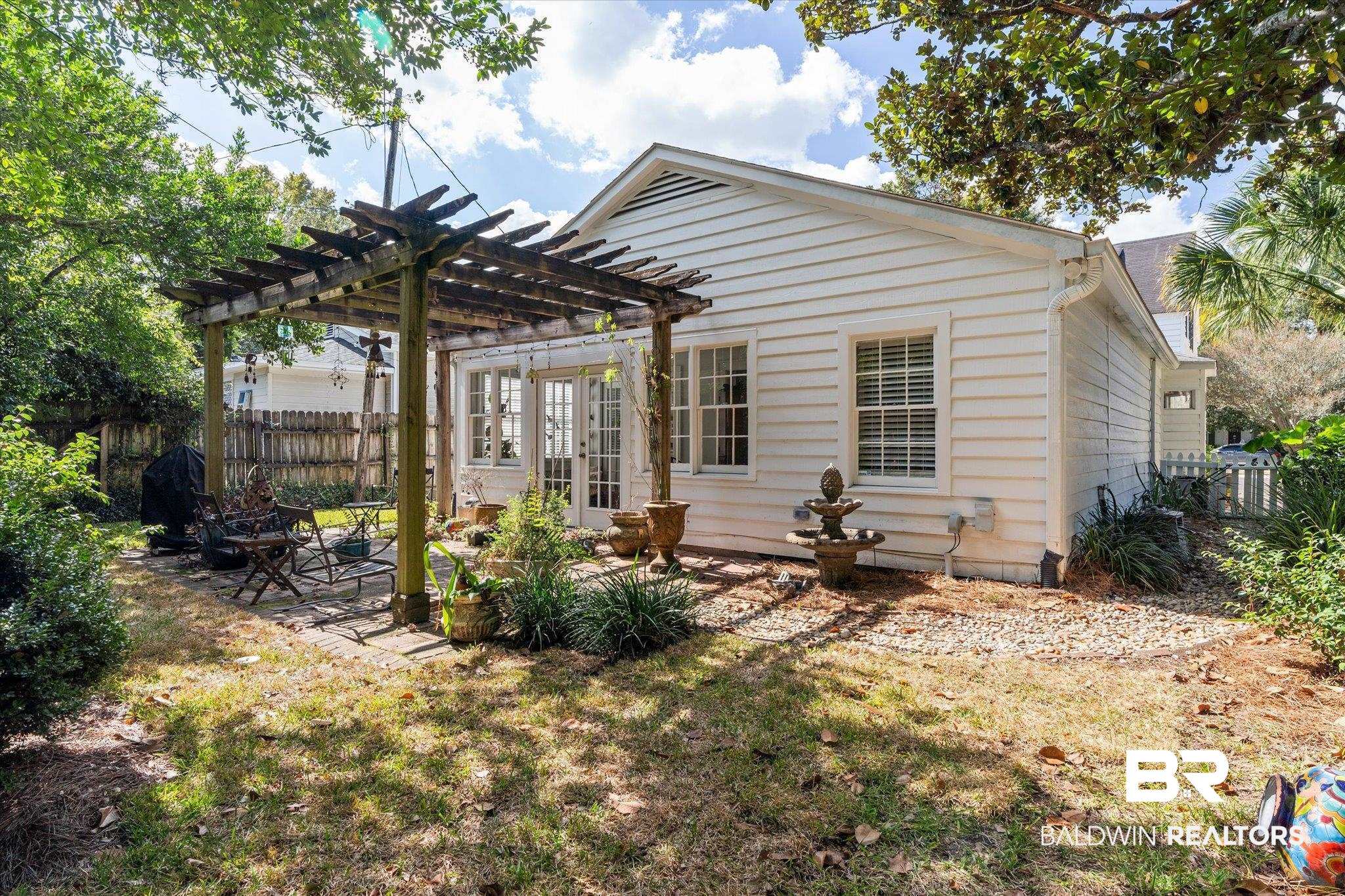 202 Woodlands Avenue Mobile, AL 36607 - Photo 36 of 53 Rear view of property with a patio area and a pergola