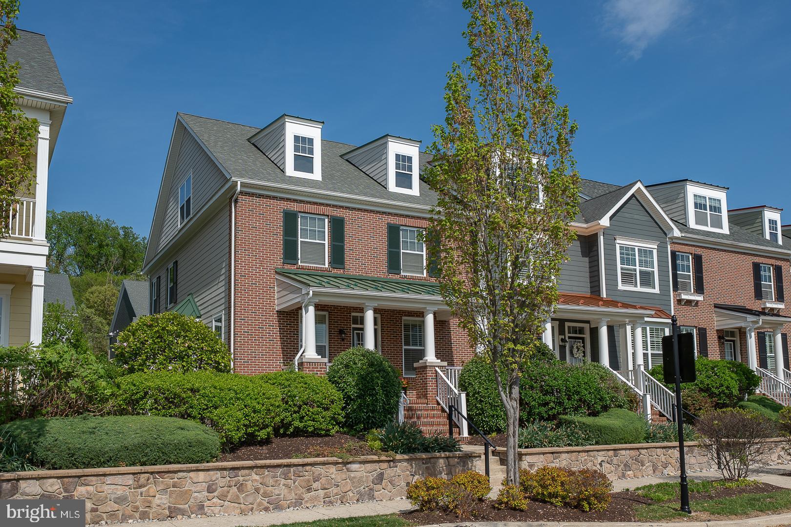 front view of a brick house with a yard