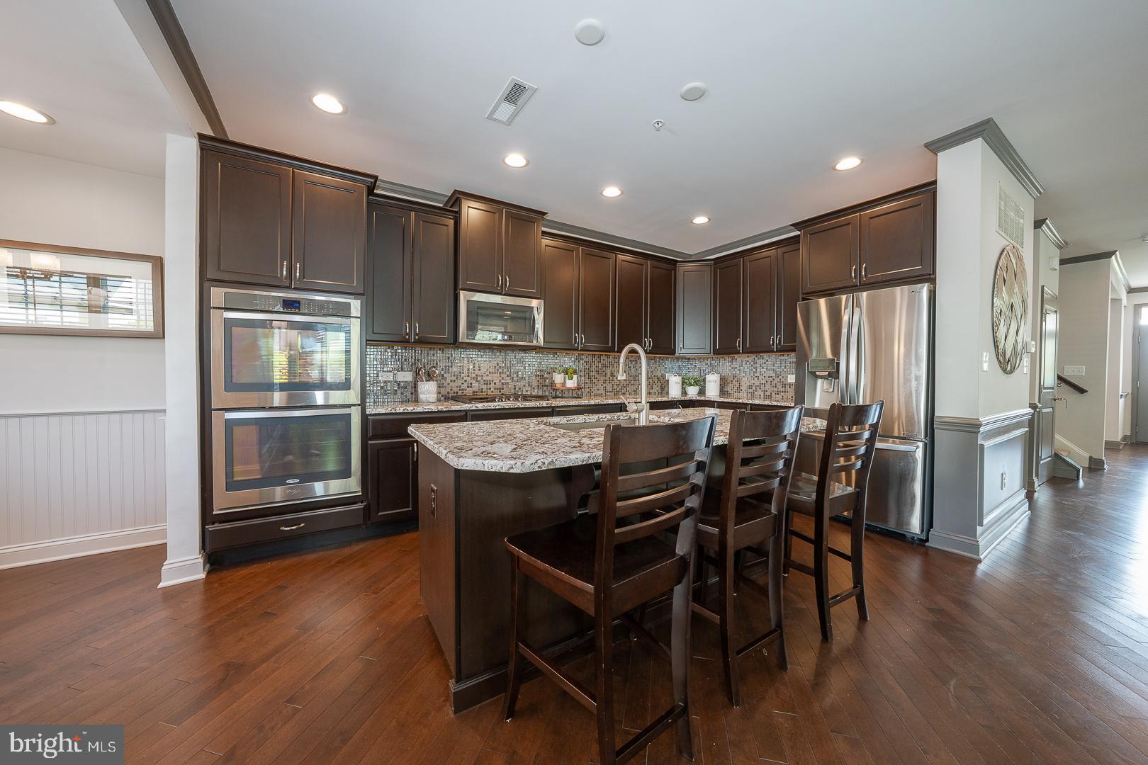 131 Spring Oak Drive Malvern, PA 19355 - Photo 16 of 93 a kitchen with kitchen island granite countertop wooden floors cabinets and stainless steel appliances