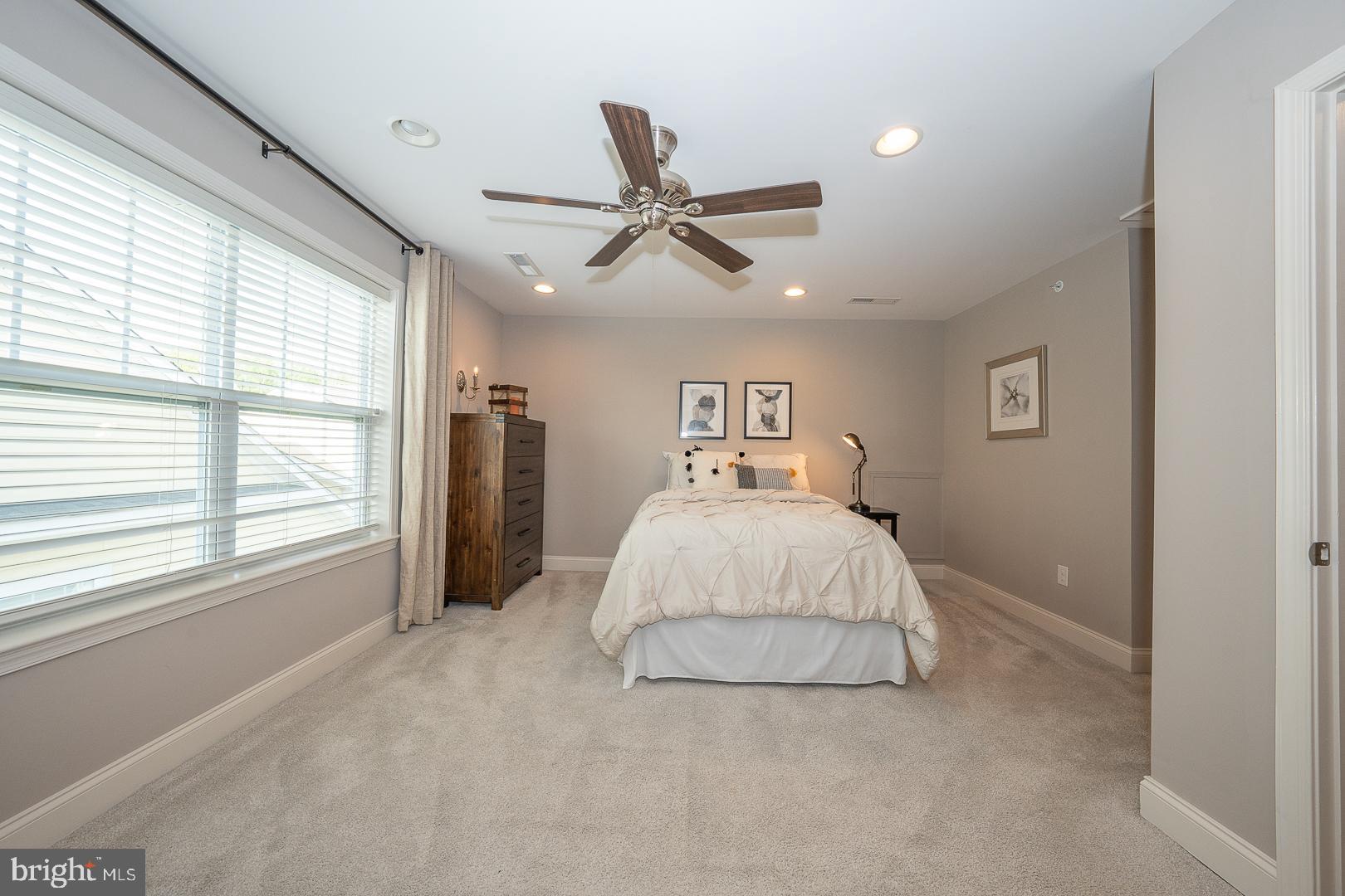 131 Spring Oak Drive Malvern, PA 19355 - Photo 50 of 93 a spacious bedroom with a large bed and a chandelier
