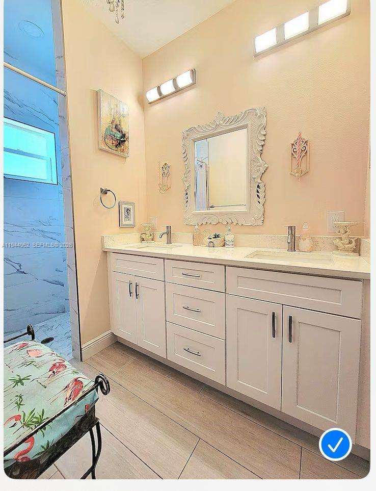562 Flamingo Road Venice, FL 34293 - Photo 11 of 15 a spacious bathroom with double sink and a mirror