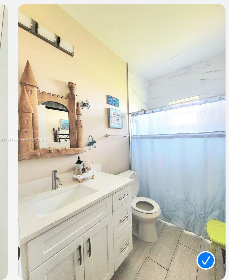562 Flamingo Road Venice, FL 34293 - Photo 9 of 15 a bathroom with a sink mirror vanity and toilet