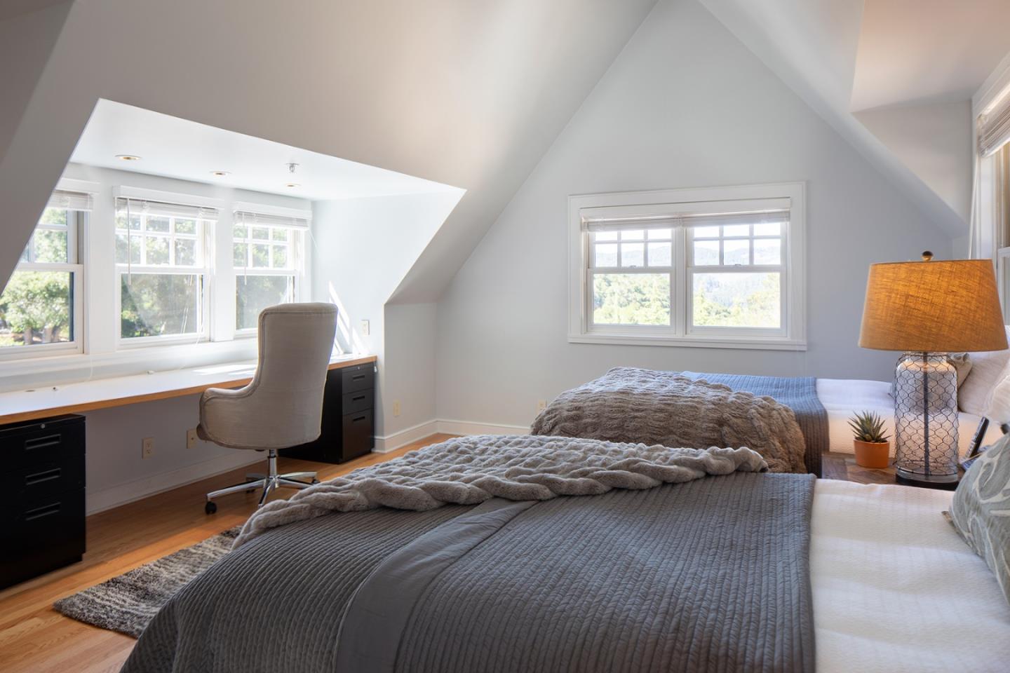 5445 Quail Way Carmel, CA 93923 - Photo 18 of 28 a bedroom with a bed a table and a dresser next to a window