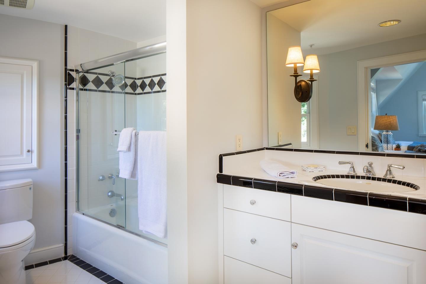 5445 Quail Way Carmel, CA 93923 - Photo 19 of 28 a bathroom with a granite countertop sink and a mirror