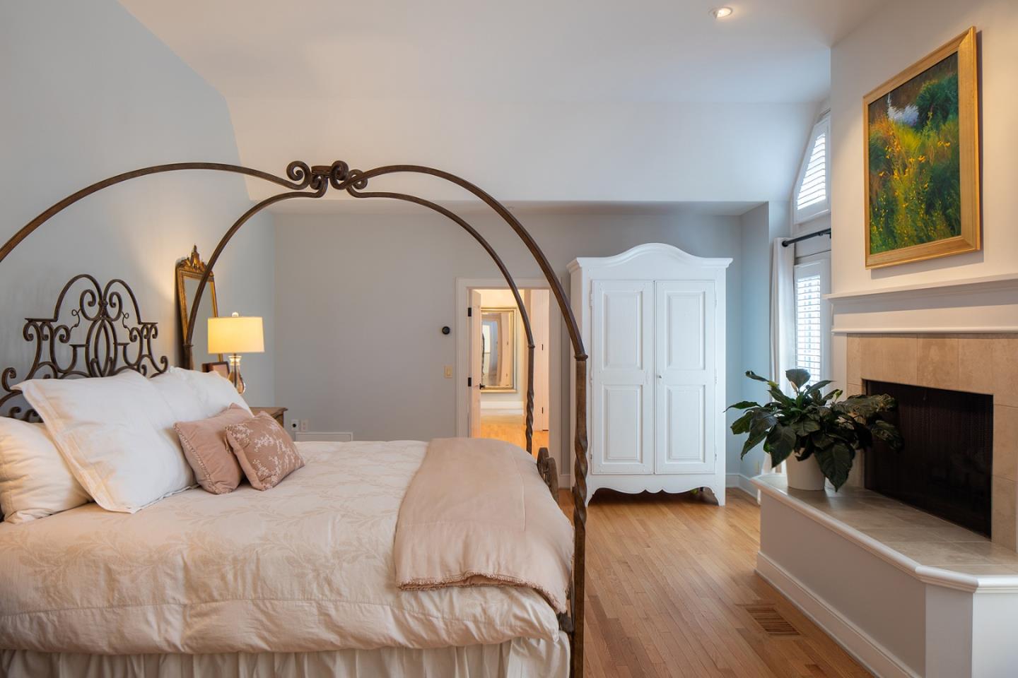 5445 Quail Way Carmel, CA 93923 - Photo 10 of 28 a bedroom with a bed a mirror and a potted plant
